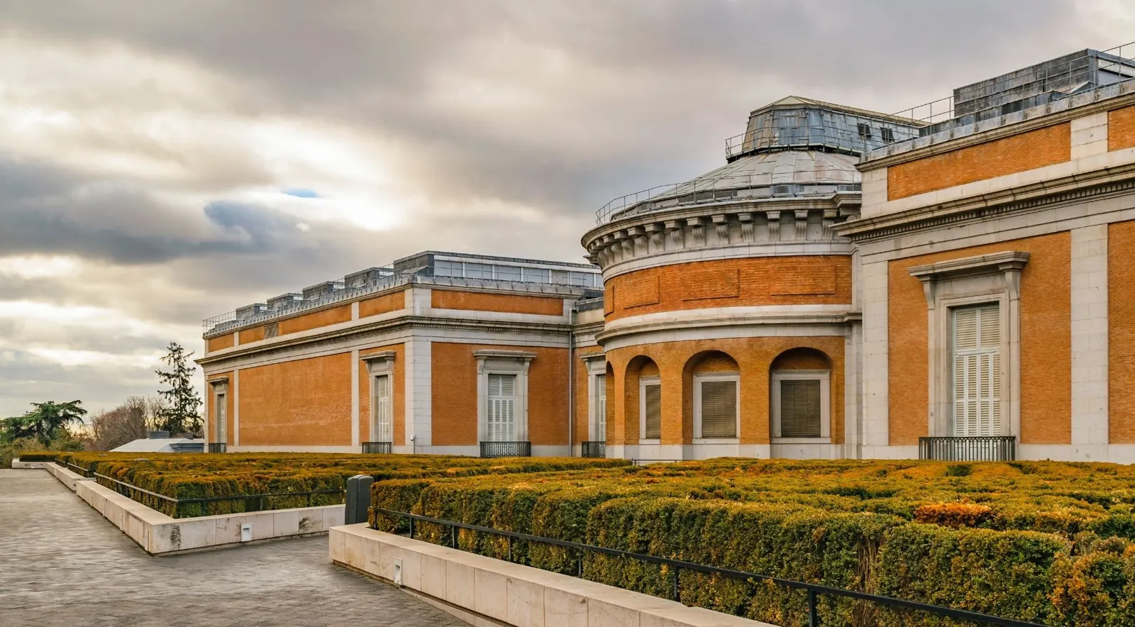 Prado Museum exterior beside clipped hedges